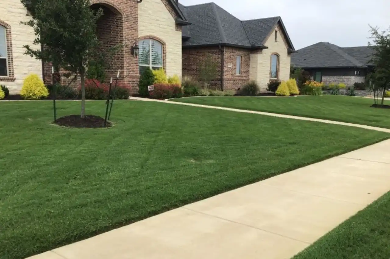A healthy green Bermuda lawn being mowed in Midlothian, Texas